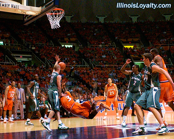 Chester Frazier throws up a shot after getting knocked down in the lane