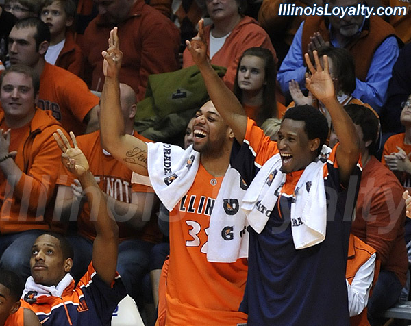 Mike Davis, Demetri McCamey and DJ Richardson celebrate Crandall Head's banked-in three-pointer