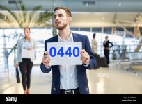 business-man-at-the-airport-holding-a-blank-welcome-sign-as-a-service-to-the-guest-PYM95N.jpg
